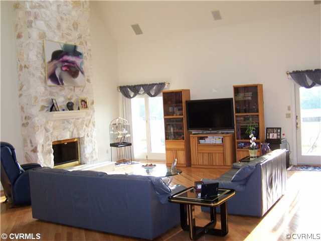 2360 Windy Run Road Manakin-Sabot, VA 23103 - Photo 4 of 12 a living room with furniture a flat screen tv and a fireplace