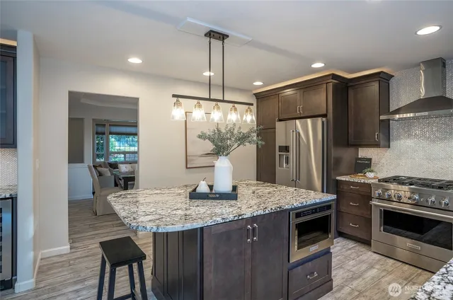 a kitchen with a stove and a refrigerator