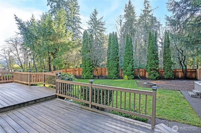 a view of balcony with wooden floor and fence