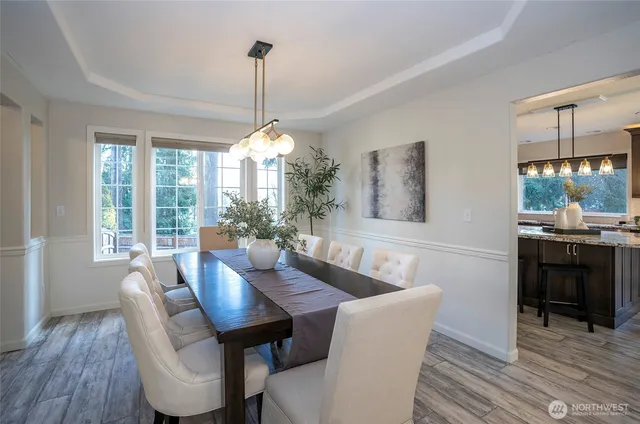 a kitchen with granite countertop kitchen island stainless steel appliances a sink stove and refrigerator