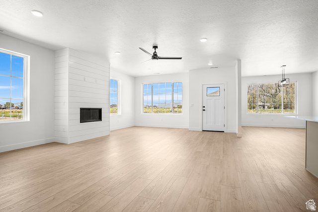 1631 West Century Lane, Unit C Mapleton, UT 84664 - Photo 13 of 31 Spacious living area featuring light wood-finish flooring and multiple windows for abundant natural light