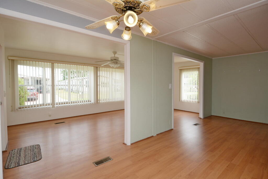 623 Periwinkle Circle Barefoot Bay, FL 32976 - Photo 16 of 37 a view of an empty room with wooden floor and a window