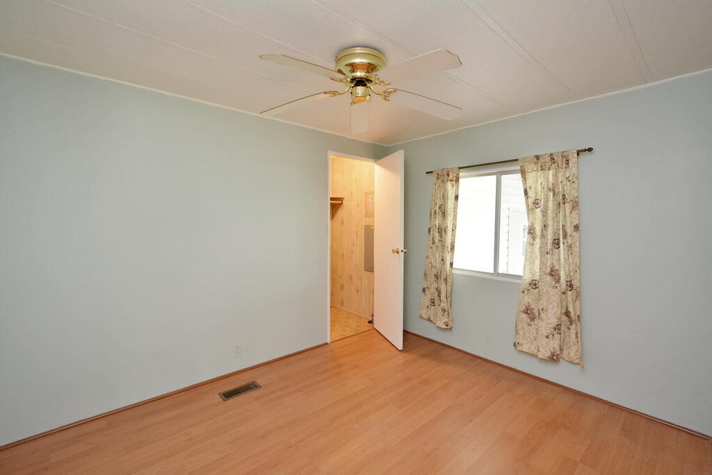 623 Periwinkle Circle Barefoot Bay, FL 32976 - Photo 19 of 37 an empty room with a window