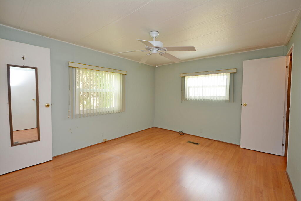 623 Periwinkle Circle Barefoot Bay, FL 32976 - Photo 22 of 37 an empty room with windows and fan