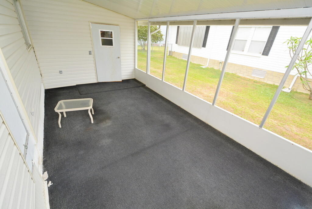 623 Periwinkle Circle Barefoot Bay, FL 32976 - Photo 27 of 37 a view of an empty room with a window