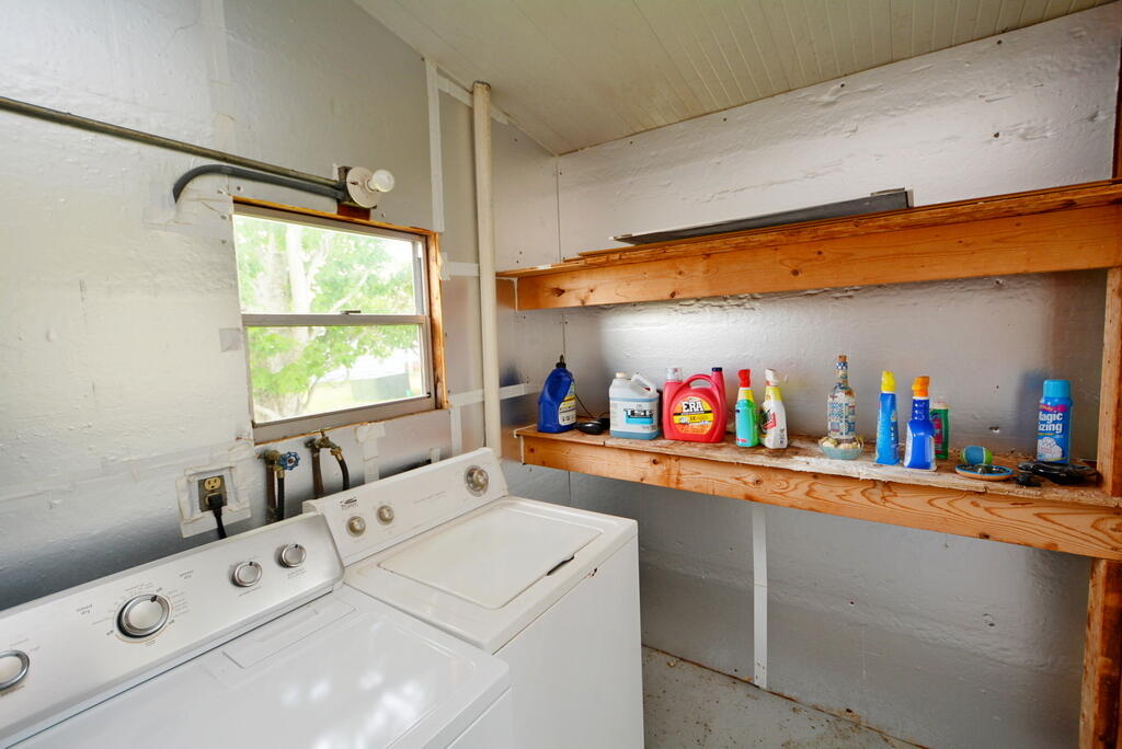 623 Periwinkle Circle Barefoot Bay, FL 32976 - Photo 30 of 37 a utility room with dryer and washer