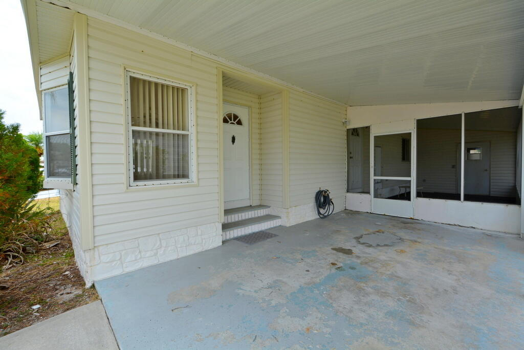 623 Periwinkle Circle Barefoot Bay, FL 32976 - Photo 31 of 37 front view of a house with a yard