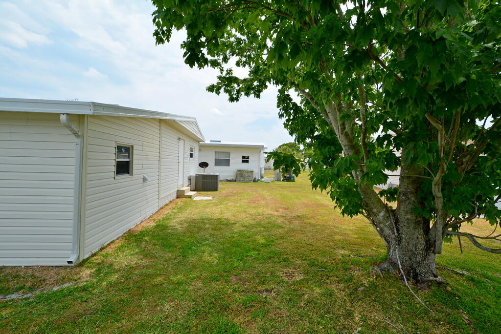 623 Periwinkle Circle Barefoot Bay, FL 32976 - Photo 33 of 37 a view of a back yard of the house