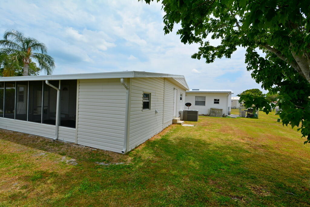 623 Periwinkle Circle Barefoot Bay, FL 32976 - Photo 34 of 37 a front view of a house with a yard