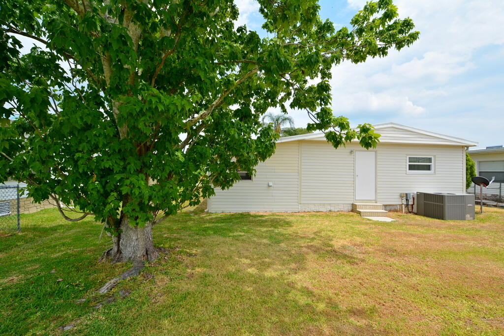 623 Periwinkle Circle Barefoot Bay, FL 32976 - Photo 37 of 37 a view of a house with a yard