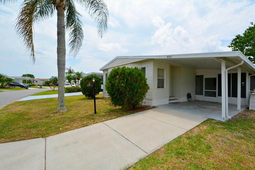 623 Periwinkle Circle Barefoot Bay, FL 32976 - Photo 4 of 37 a view of a house with backyard and tree