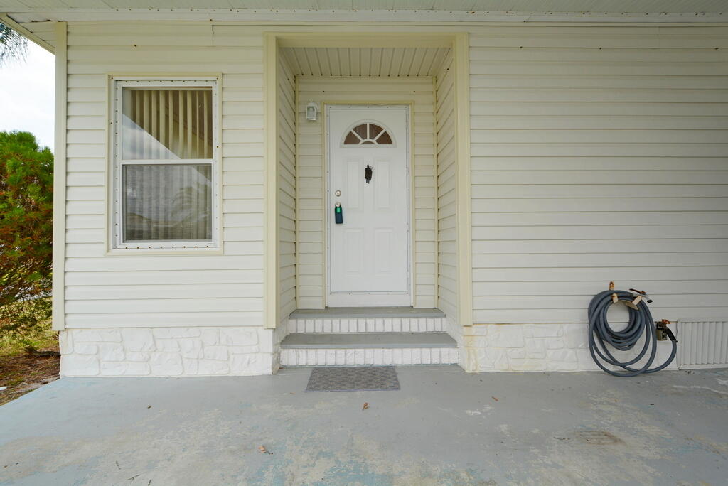 623 Periwinkle Circle Barefoot Bay, FL 32976 - Photo 5 of 37 a house with a door