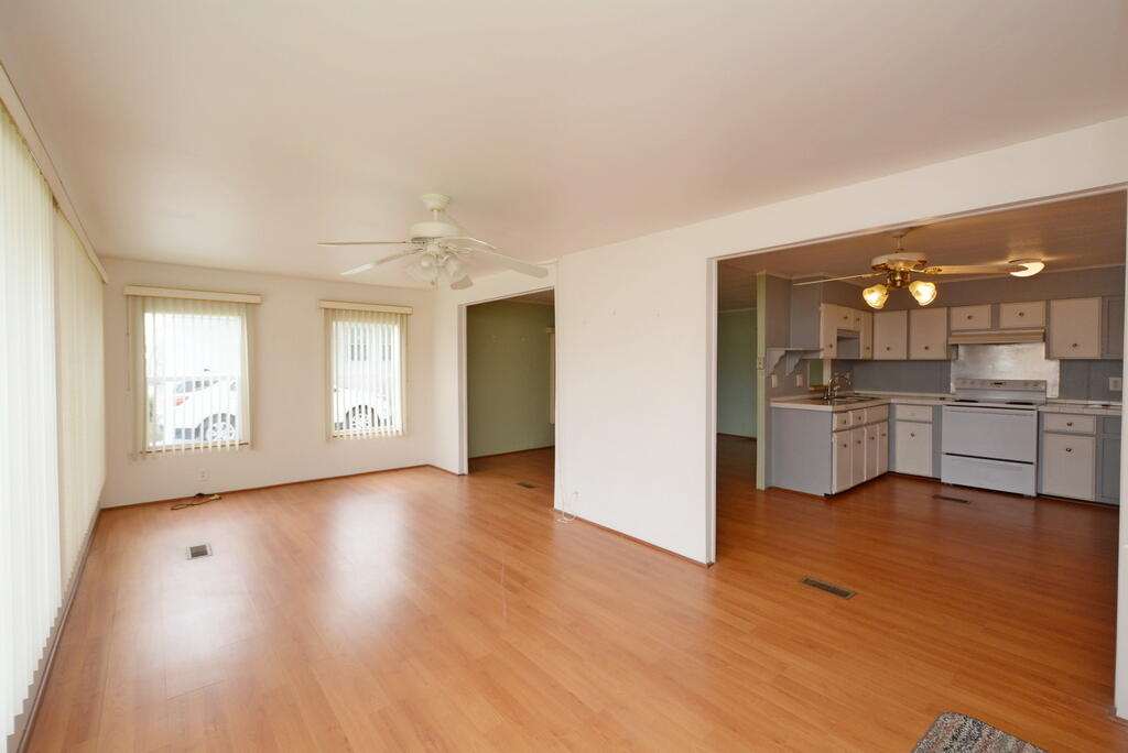 623 Periwinkle Circle Barefoot Bay, FL 32976 - Photo 7 of 37 a view of a kitchen and a sink cabinet windows and a fireplace