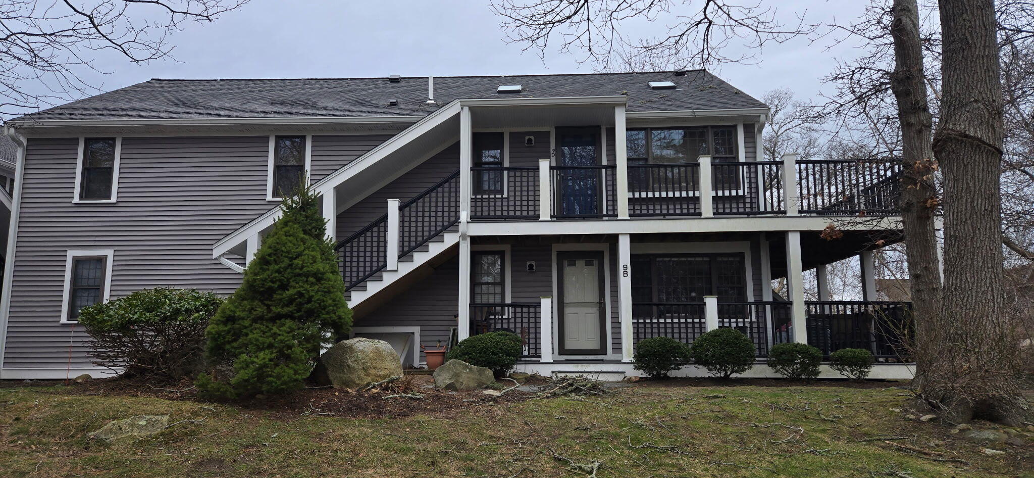 190 Route 6A, Unit 9B Orleans, MA 02653 - Photo 1 of 12 a view of brick house with yard and large tree
