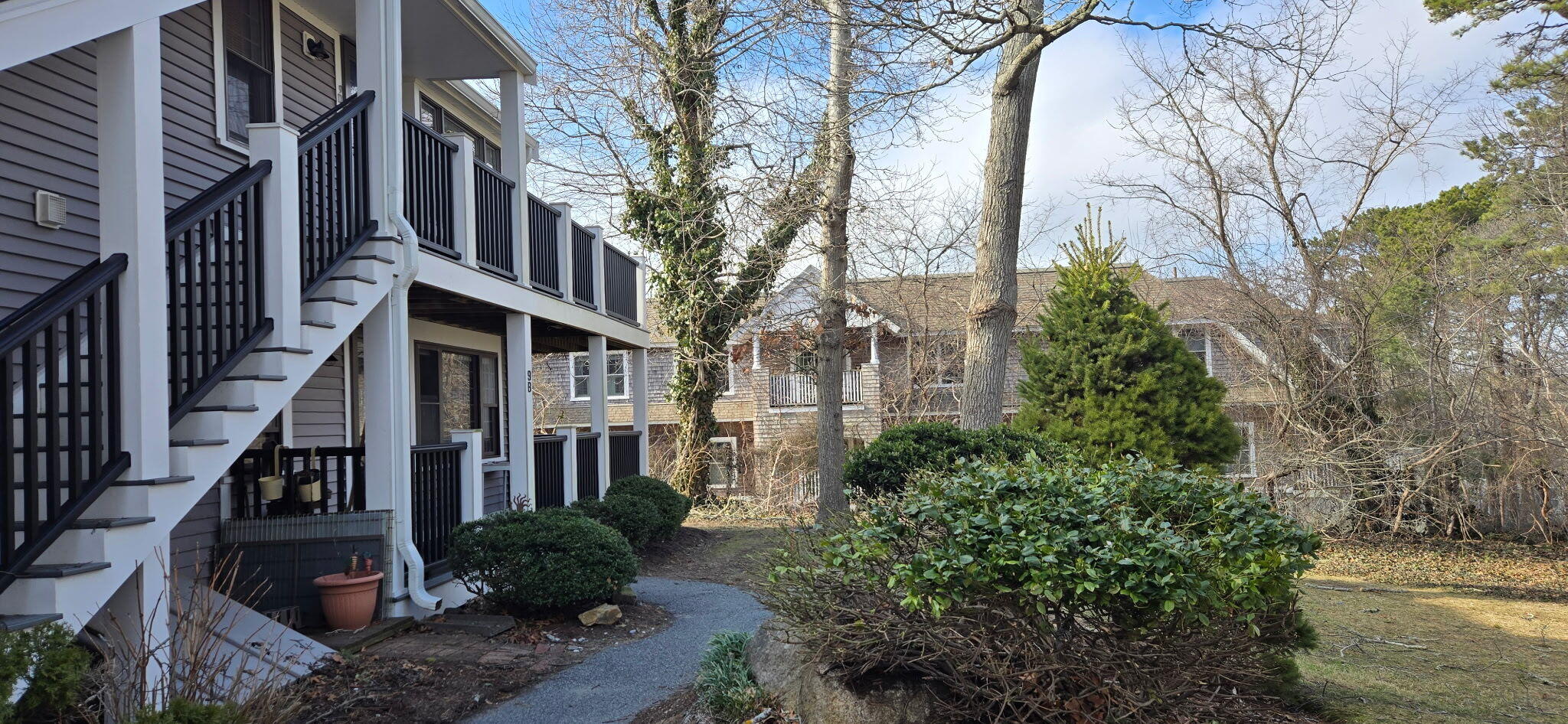 190 Route 6A, Unit 9B Orleans, MA 02653 - Photo 2 of 12 a view of a pathway both side of house