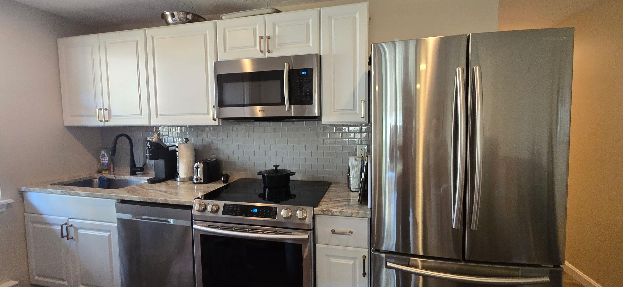 190 Route 6A, Unit 9B Orleans, MA 02653 - Photo 7 of 12 a kitchen with stainless steel appliances granite countertop a refrigerator and a stove top oven