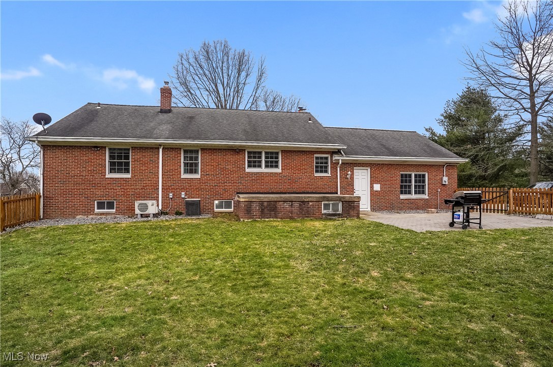33825 Cannon Road Solon, OH 44139 - Photo 4 of 44 Back of house with central air condition unit, fence, a patio, and a lawn