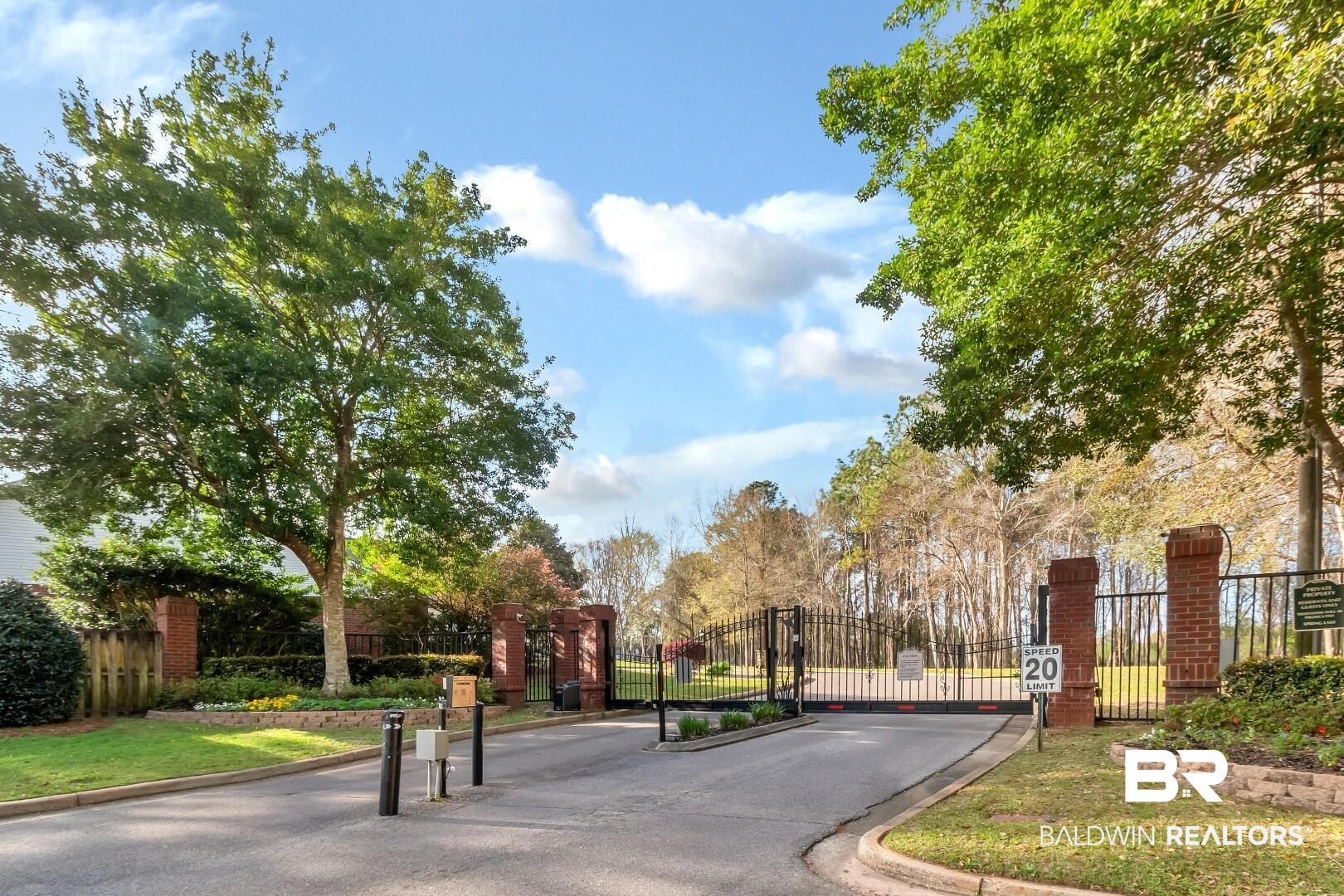 672 Spring Lake Drive East Mobile, AL 36695 - Photo 1 of 26 View of street with a gate, curbs, and a gated entry