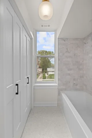 a bathroom with a bathtub and shower