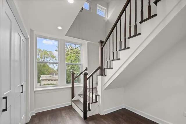 a view of entryway with wooden floor and stairs