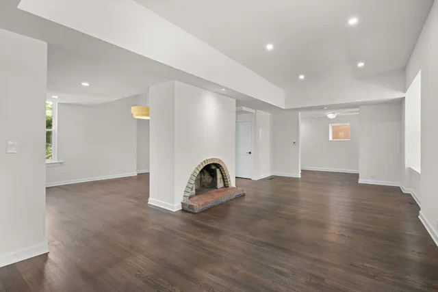 a view of a room with wooden floor and window