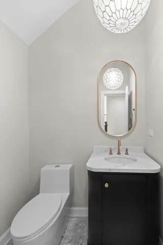 a bathroom with a toilet a sink and mirror