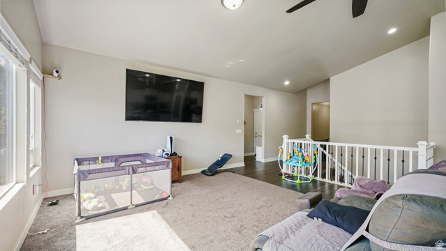 6062 Spring Street Stansbury Park, UT 84074 - Photo 10 of 36 Spacious living area featuring high ceilings, recessed lighting, and large windows providing abundant natural light