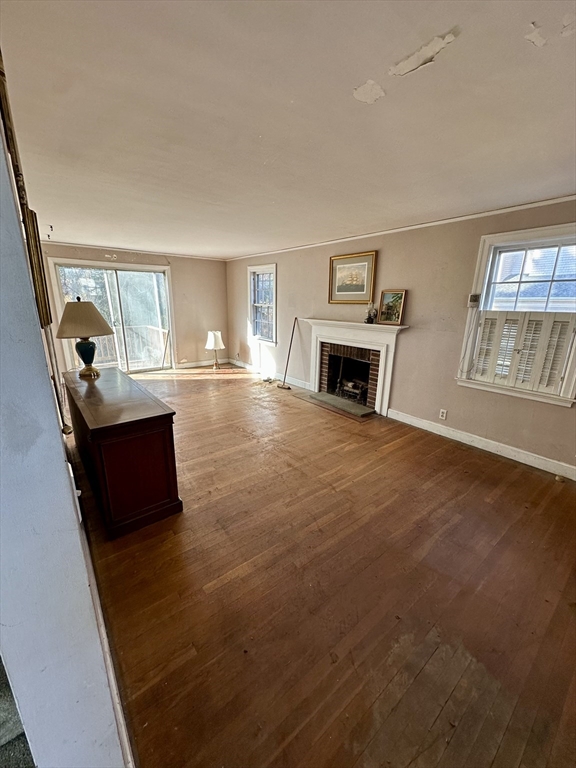 18 Cushing Road Brookline, MA 02445 - Photo 5 of 6 a view of a livingroom with furniture a fireplace and wooden floor