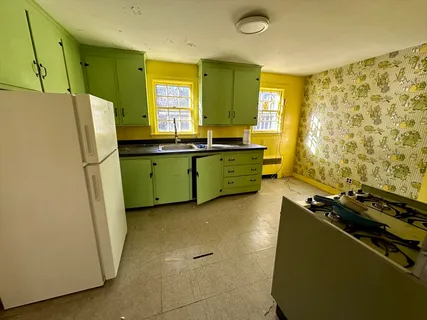a kitchen with sink a refrigerator and a stove