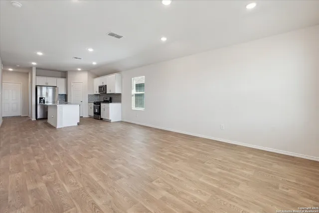 a view of a kitchen with a sink and a refrigerator