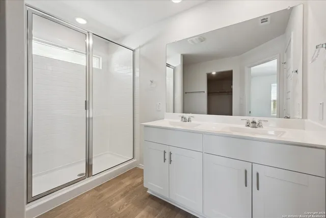 a bathroom with double sink and a mirror
