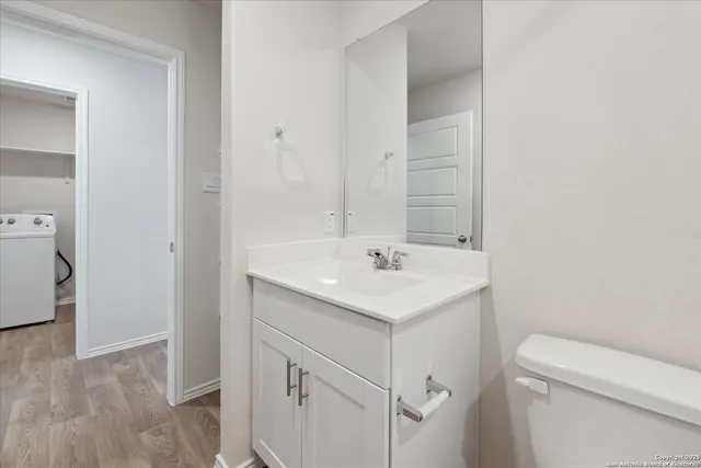 a bathroom with a sink a toilet and a mirror