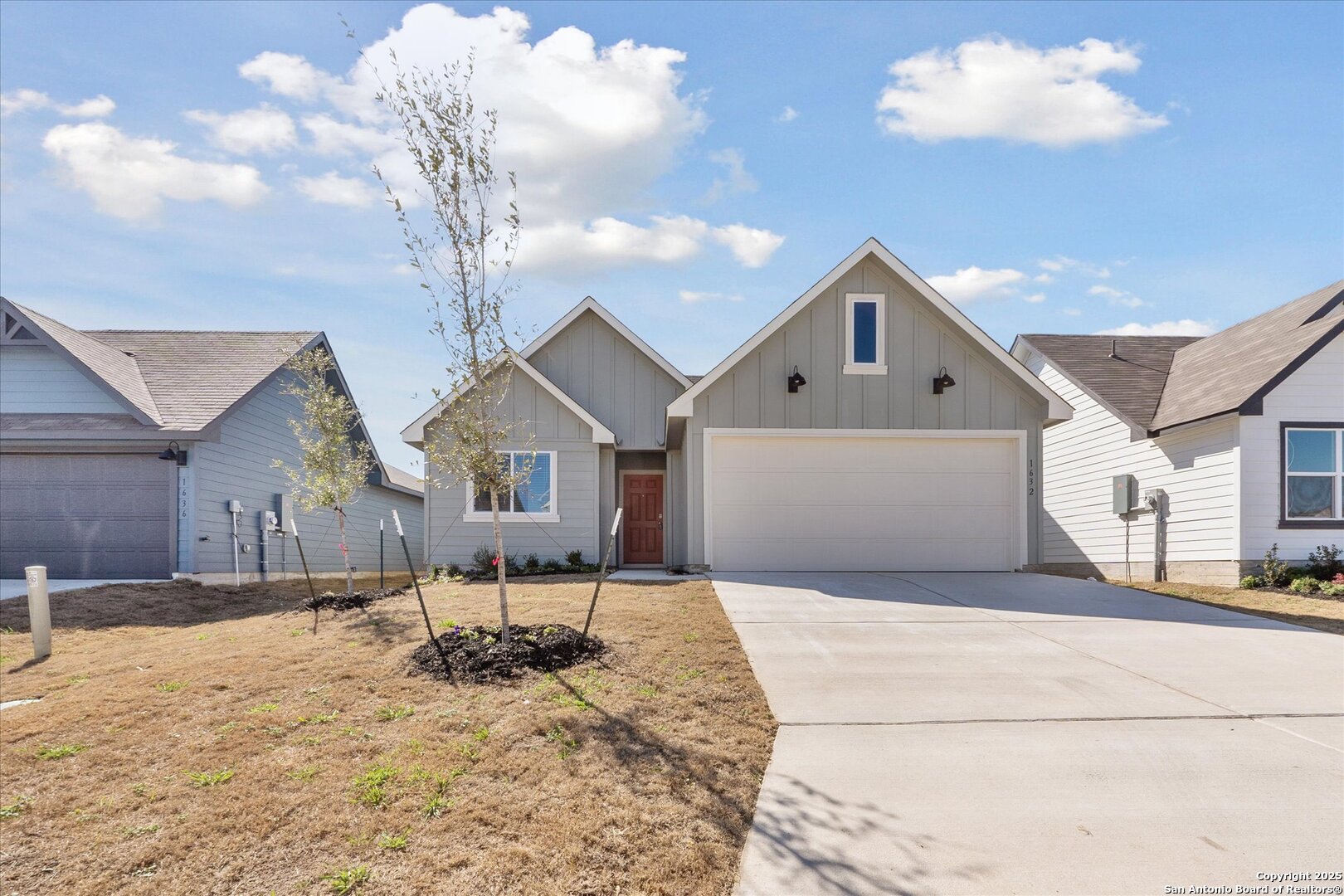 1632 Layne Loop New Braunfels, TX 78130 - Photo 3 of 34 a front view of a house with a yard