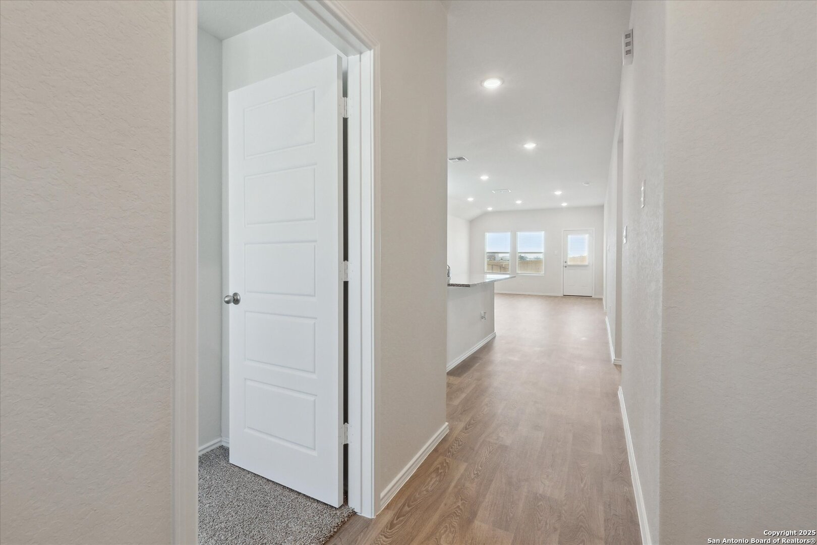 1632 Layne Loop New Braunfels, TX 78130 - Photo 7 of 34 a view of a hallway with wooden floor