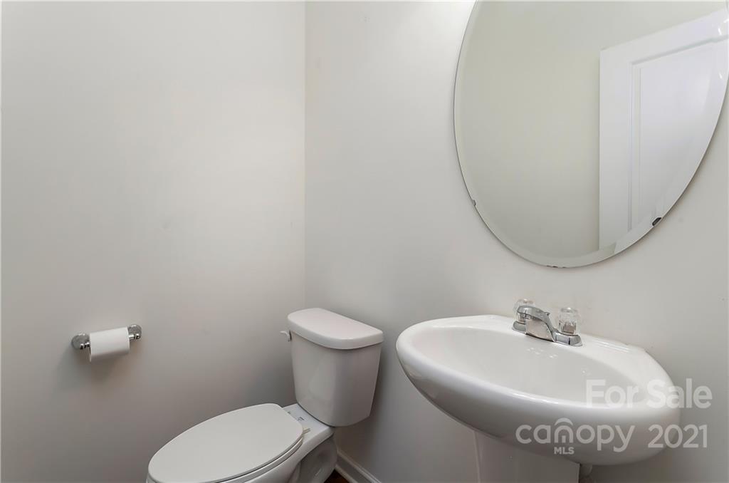 3016 Aransas Road Charlotte, NC 28214 - Photo 12 of 24 a white toilet sitting next to a bathroom sink
