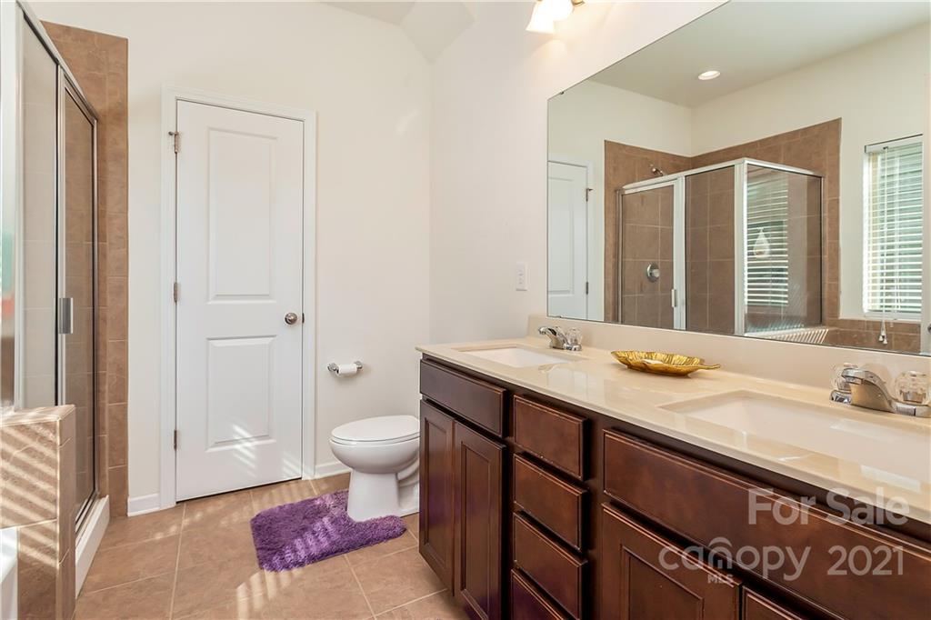 3016 Aransas Road Charlotte, NC 28214 - Photo 14 of 24 a bathroom with a sink and a mirror