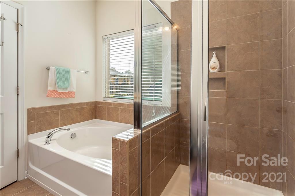 3016 Aransas Road Charlotte, NC 28214 - Photo 15 of 24 a bathroom with a bathtub and a shower
