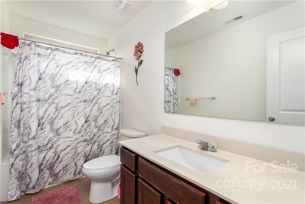 3016 Aransas Road Charlotte, NC 28214 - Photo 20 of 24 a bathroom with a granite countertop sink and a mirror