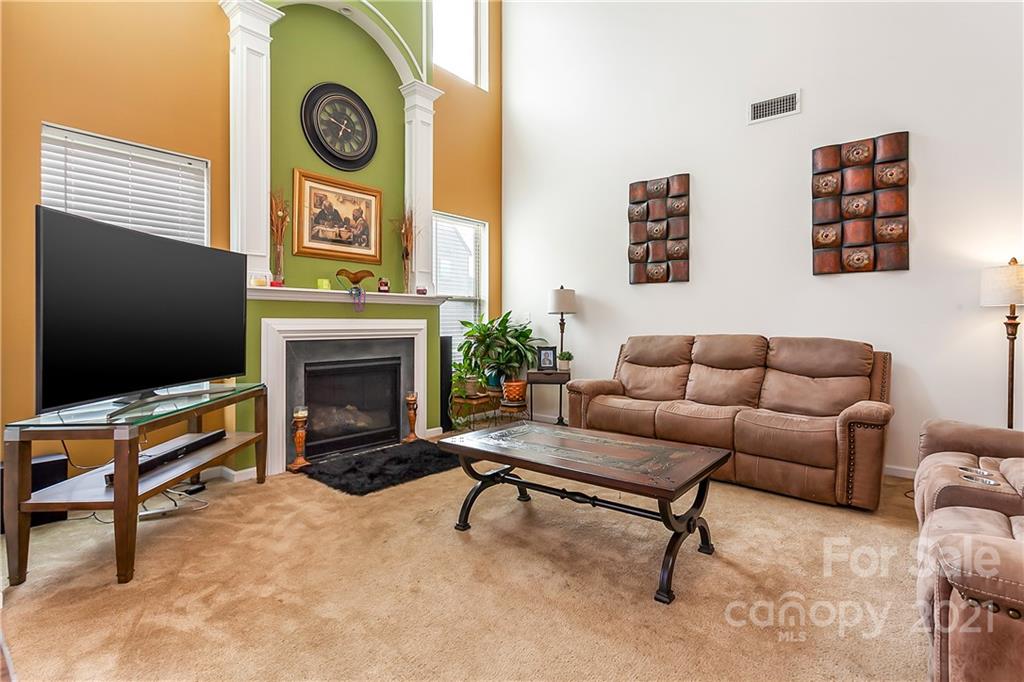 3016 Aransas Road Charlotte, NC 28214 - Photo 6 of 24 a living room with furniture a flat screen tv and a fireplace