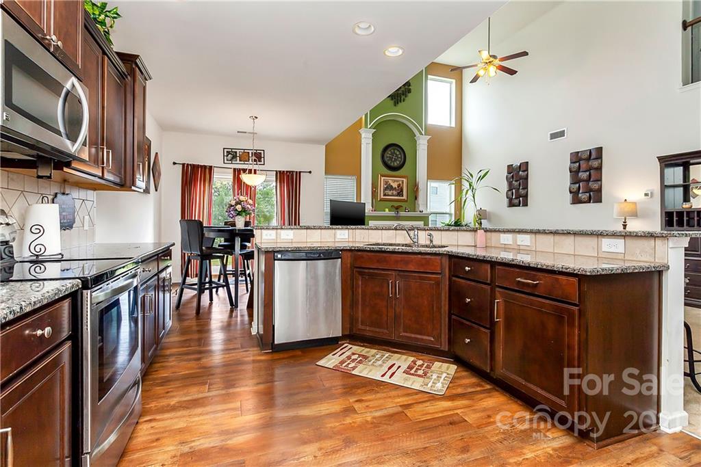 3016 Aransas Road Charlotte, NC 28214 - Photo 10 of 24 a kitchen with stainless steel appliances granite countertop a sink stove and cabinets
