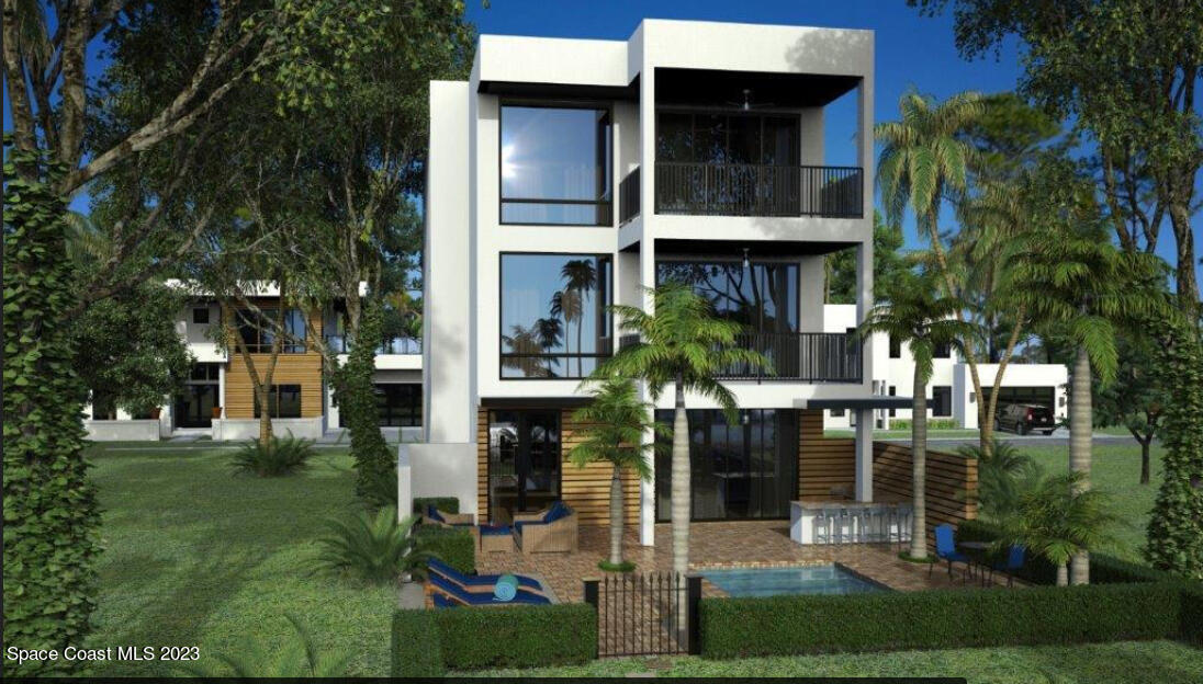 14 Ocean River Drive Cocoa Beach, FL 32931 - Photo 2 of 15 a view of a building with a yard and potted plants