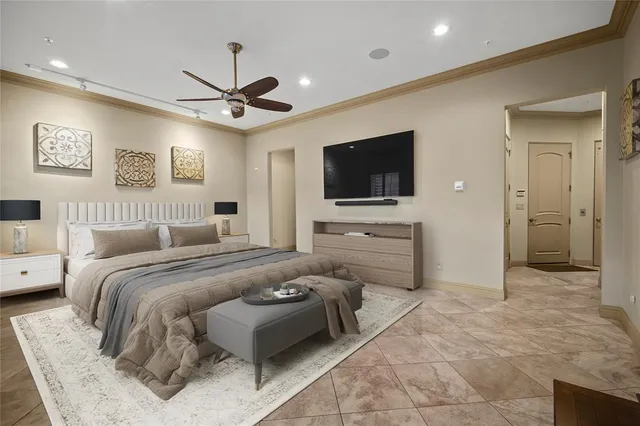 a spacious bedroom with a bed and a flat screen tv