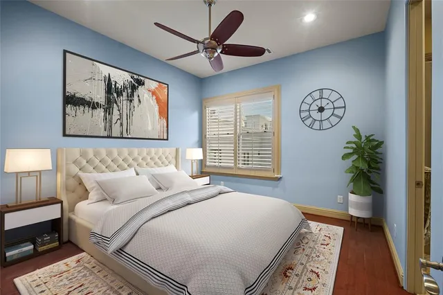 a bedroom with a bed and a painting on the wall