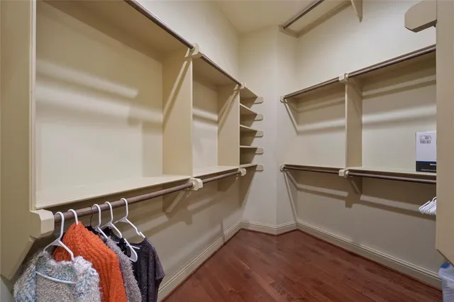 a view of walk in closet with clothes and shoes