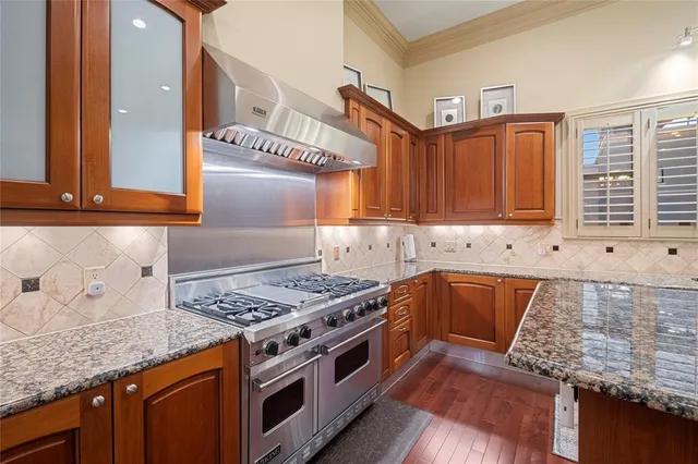 a kitchen with stainless steel appliances granite countertop a stove and a sink