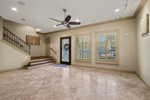 a view of an empty room with a fireplace and a window