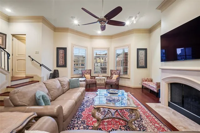 a living room with furniture a fireplace and a flat screen tv