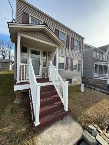 a front view of a house with stairs