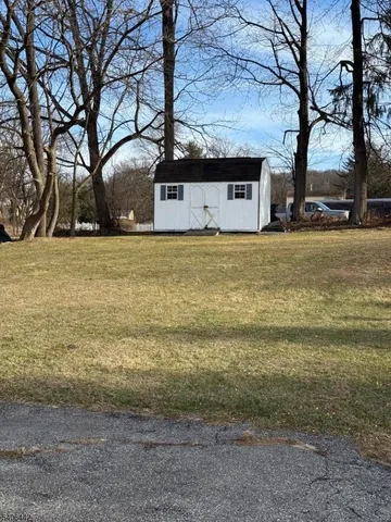 a view of road with card parked on side and road