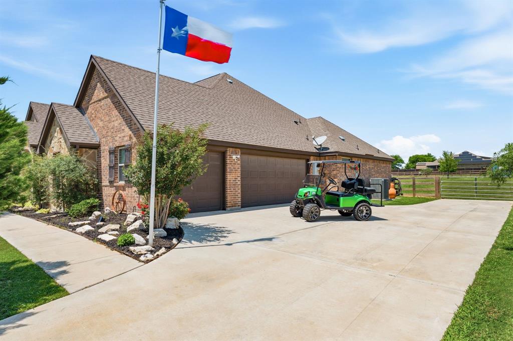 140 Heather Lane Decatur, TX 76234 - Photo 36 of 39 a front view of a house with a yard and potted plants